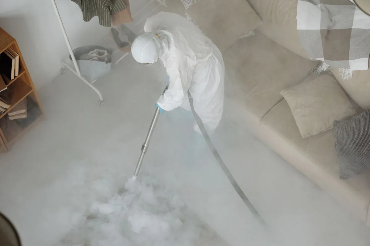 Biohazard cleanup technician in protective equipment, Nashua, IA